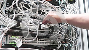 One male IT engineer working in a data center with rows of server racks and super computers.