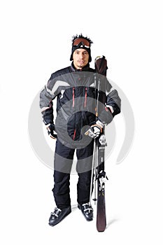 One male skier posing with full equipment on a white background