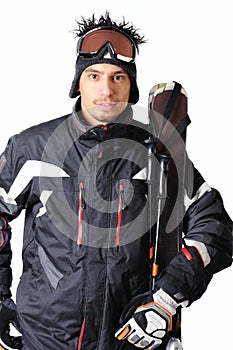 One male skier posing with full equipment on a white background