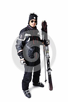 One male skier posing with full equipment on a white background