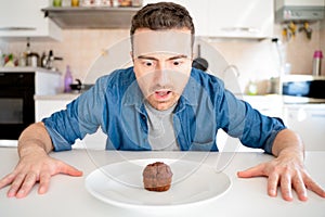 One man on diet tempted by chocolate sweet