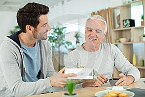 one man giving present to another man