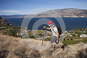 One Man Hiking With Lakeview Background