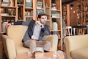 One man looking sitting coffee bar indoors interior