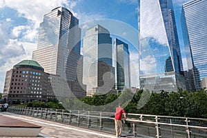 One man looks at World Trade Center glass building and NYC cityscape