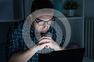 One man portrait using computer late at night