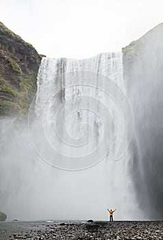 One man posing at Skogafoss waterfall