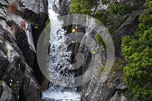 One man rappelling the Arado Waterfall cascata do arado in the Peneda Geres National Park photo