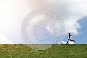 One man running on hill with cloud and blue sky