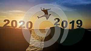 One man silhouettes jump, float across numbers, 2019 enters the year 2020