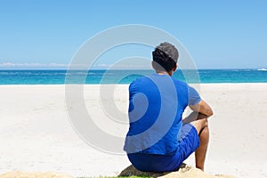 One man sitting alone at the beach