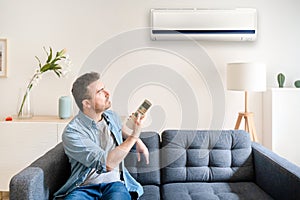 One man suffering summer heat at home trying to cool off