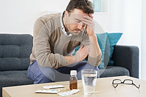 One man taking painkillers to relieve pain and headache