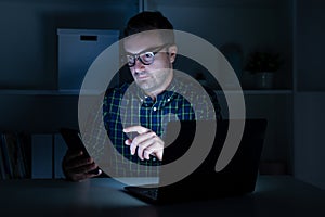 One man working late at night on computer