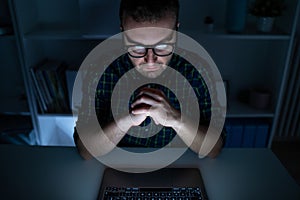 One man working late at night on computer