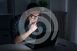 One man working late at night on computer