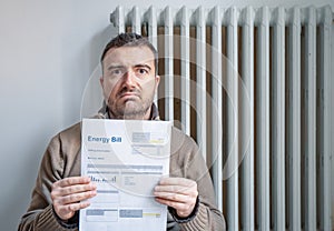 One man worried about bills reading home heating utilities increase costs