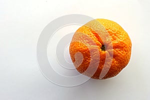 One Mandarin Mandarine orange against a White Background