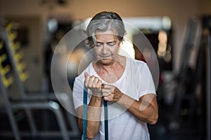 One mature woman doig exercise at the gym to be healthy and fitness senior - training every day lifestyle and concept