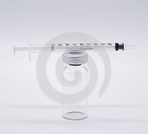 One medical Vaccine ampules one syringe on a white background