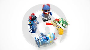 When one monster dog on a white background is knocked down by a robot wearing a blue helmet, two other robots are gathering around