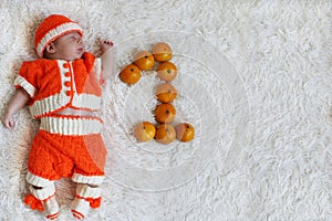 One month baby. Sleeping newborn baby one month old in orange