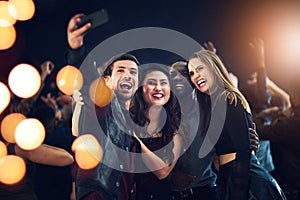 One more just because we can. Cropped shot of a diverse group of young friends taking a selfie together at a party at