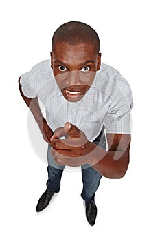 One more thing. High angle studio shot of a young man pointing toward the viewer.