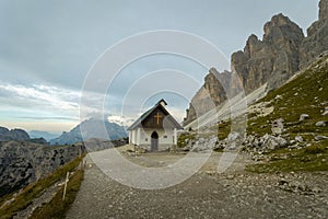 One of the most famous and spectacular views of all the Alps: the locatelli refuge, its church and the three peaks of