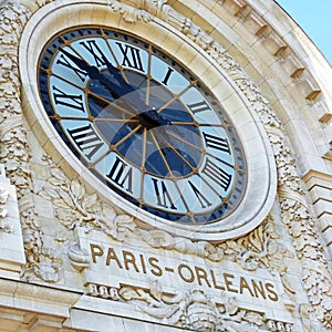 Clock at the front of a building in Paris photo