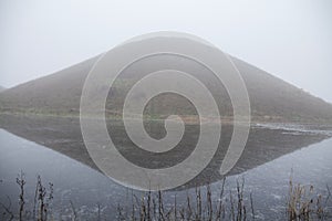 Silbury hill at avebury stone circle reflection with mist photo