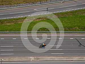 One motorcycle traveller is racing on the speedway, aerial view