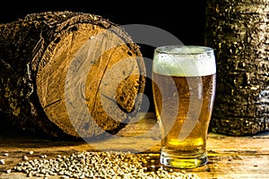 One mug of beer on a wooden table