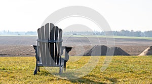 One muskoka chairs over looking the farm land