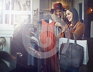 This one is a must-have. two best friends out shopping in a clothing store.