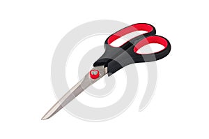 One new clean sharp metal scissors with handles of black and red colors isolated on white background