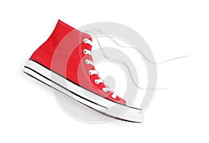 One new red stylish plimsoll on white background, top view
