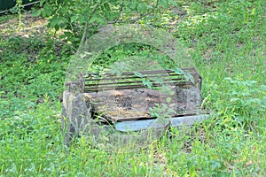 one old abandoned well covered with a brown iron rusty slab