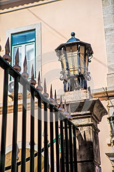 One old black iron lantern with glass