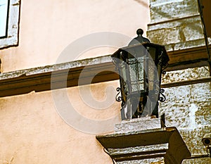 old black iron lantern with white glass