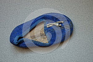 One old blue dirty cloth slipper