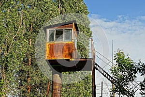 One old brown rusty iron tower observation post with a window
