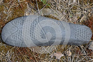 one old dirty black plastic insole shoe sole photo