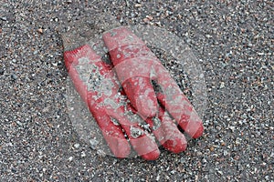 One old dirty red rubber glove