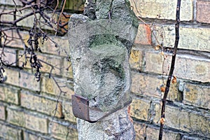 One old gray concrete pillar with brown rusty iron plate