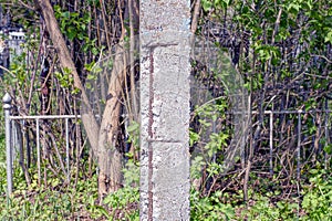 One old gray concrete pillar with rusty rebar
