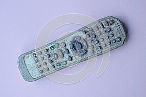 One old gray dirty plastic television remote control