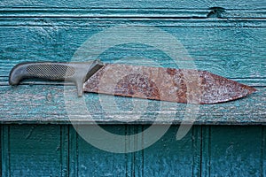 One old large machete knife with a brown rusty blade