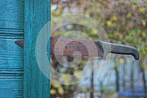 One old large machete knife with a brown rusty blade