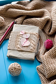 One old notebook in knitted cover with felt hearts